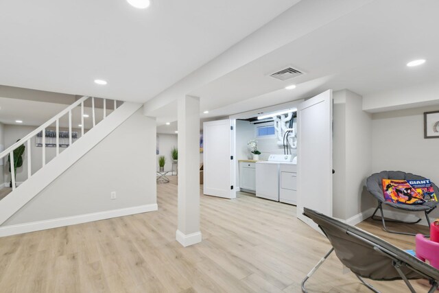 finished below grade area with recessed lighting, visible vents, stairway, light wood-type flooring, and baseboards