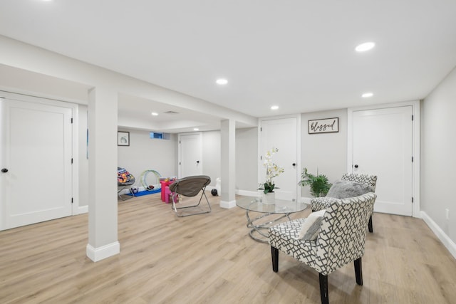 sitting room with baseboards, light wood finished floors, and recessed lighting