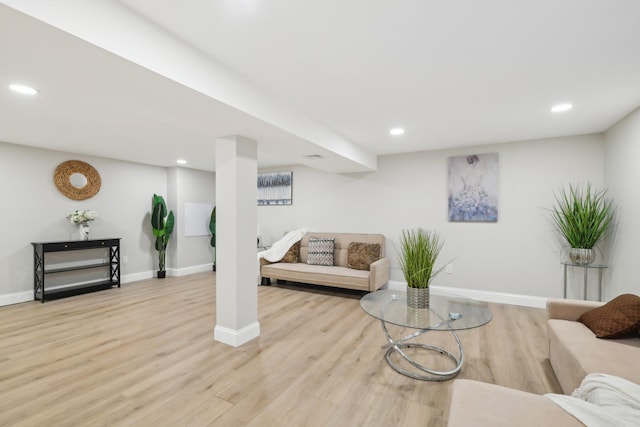 living area with recessed lighting, baseboards, and light wood finished floors