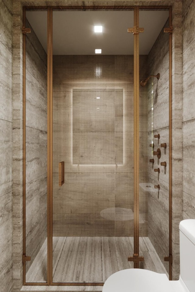 bathroom with toilet and a shower stall