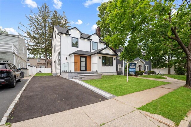 670 Emerson St, Woodmere, NY 11598 - view of front of property featuring a chimney, board and batten siding, and a residential view