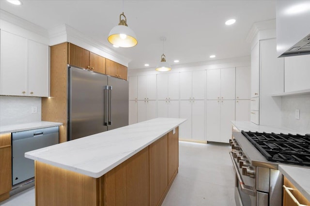 670 Emerson St, Woodmere, NY 11598 - kitchen with appliances with stainless steel finishes, wall chimney range hood, hanging light fixtures, white cabinets, and recessed lighting