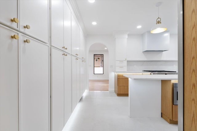 670 Emerson St, Woodmere, NY 11598 - kitchen with light countertops, white cabinets, arched walkways, hanging light fixtures, and recessed lighting