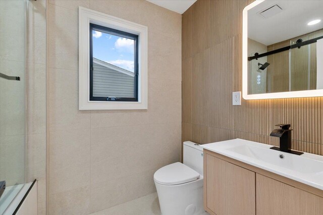 670 Emerson St, Woodmere, NY 11598 - bathroom featuring a shower with door, vanity, and tile walls