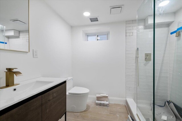 670 Emerson St, Woodmere, NY 11598 - full bathroom featuring vanity, a tile shower, and wood finished floors