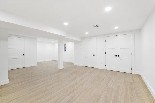 670 Emerson St, Woodmere, NY 11598 - finished below grade area with light wood-type flooring and recessed lighting