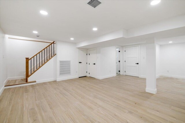 670 Emerson St, Woodmere, NY 11598 - finished basement with stairs, recessed lighting, and light wood-type flooring
