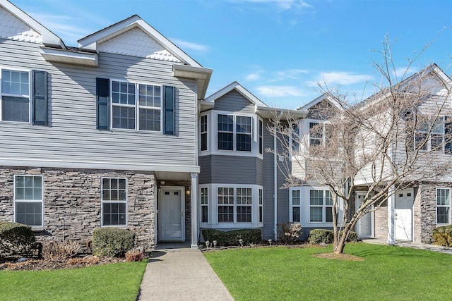 view of front of property with stone siding and a front yard