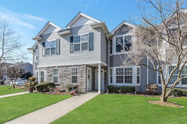 view of front of home with stone siding and a front yard