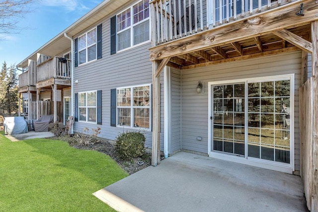 exterior space featuring a yard, a patio, and a balcony