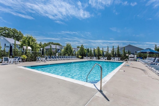 pool with fence and a patio