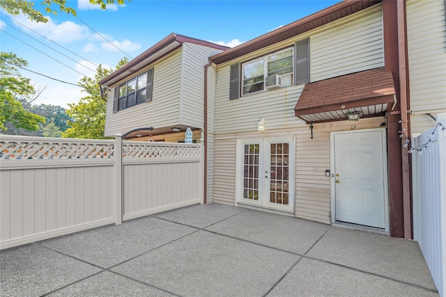 back of property featuring a patio area, a shingled roof, fence, and french doors