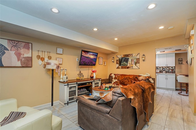 living area featuring light tile patterned floors, baseboards, and recessed lighting