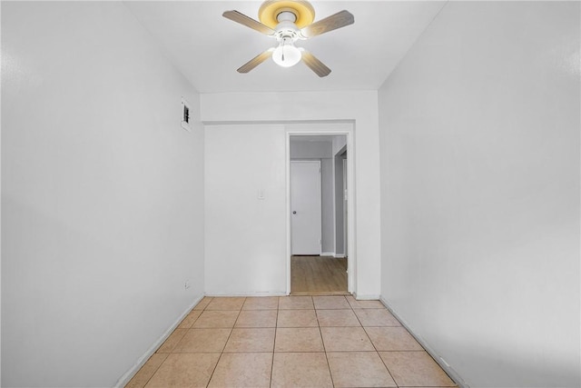 unfurnished room featuring ceiling fan and light tile patterned floors