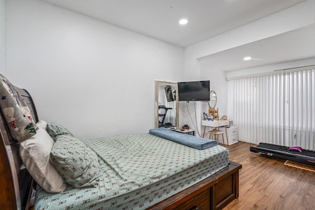 bedroom with recessed lighting and wood finished floors