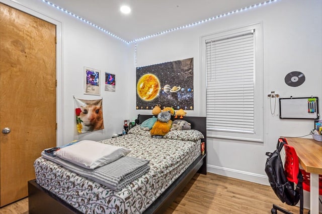 bedroom featuring recessed lighting, baseboards, and wood finished floors