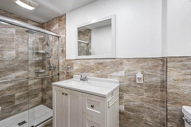 full bath featuring toilet, a shower stall, tile walls, and vanity