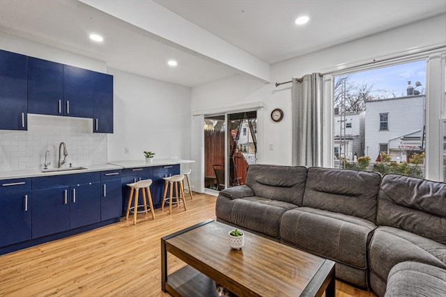 living room featuring a healthy amount of sunlight, light wood-style floors, and recessed lighting