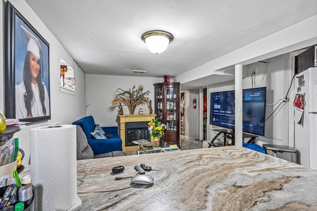 bedroom featuring a glass covered fireplace and visible vents