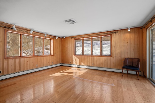 spare room featuring rail lighting, visible vents, and light wood-style flooring