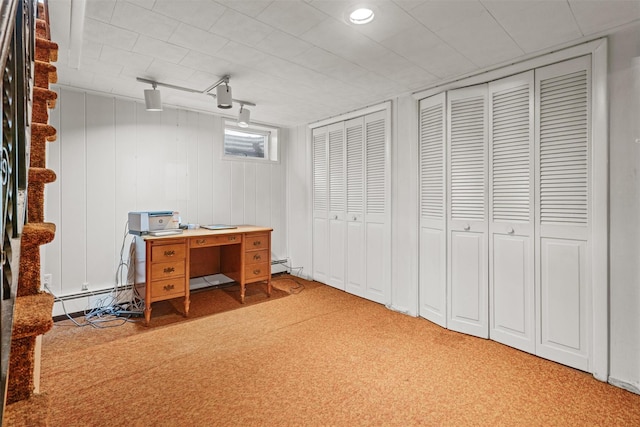 carpeted home office with a baseboard heating unit, baseboard heating, and track lighting