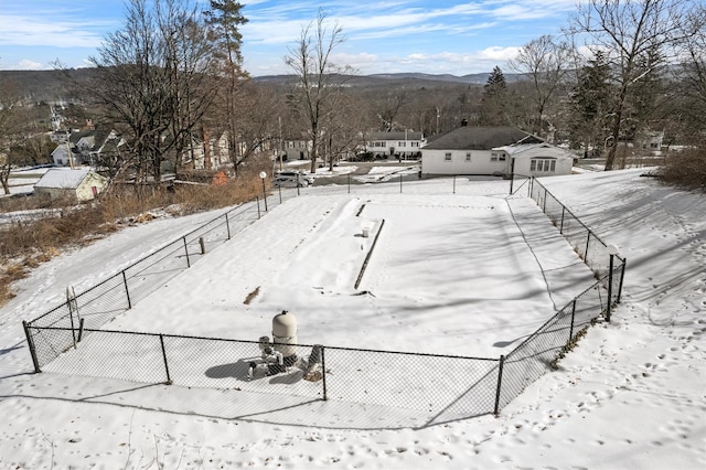 snowy aerial view featuring a mountain view