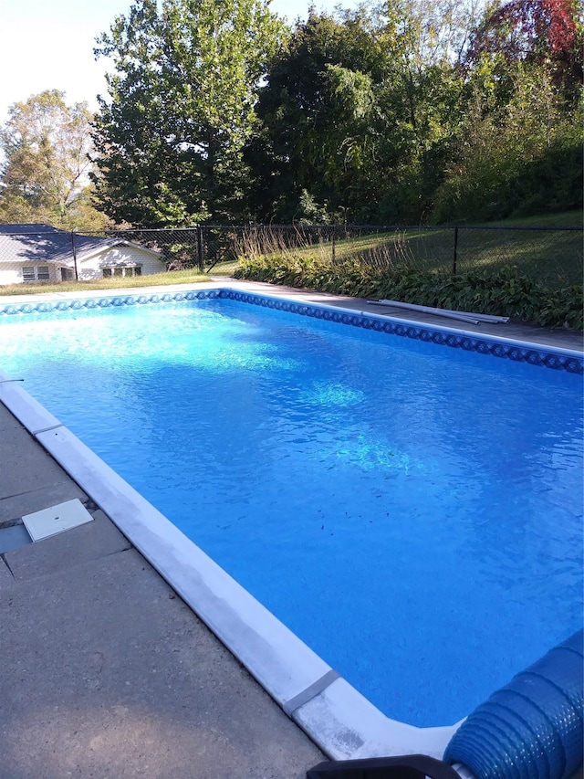 view of swimming pool featuring fence and a fenced in pool