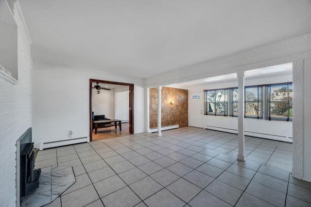 unfurnished living room featuring a baseboard heating unit, a baseboard radiator, decorative columns, and light tile patterned floors