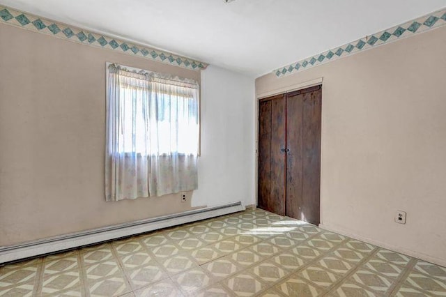 unfurnished bedroom with a baseboard heating unit, a closet, and light floors