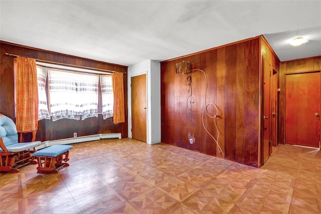 living area featuring a baseboard radiator and wooden walls