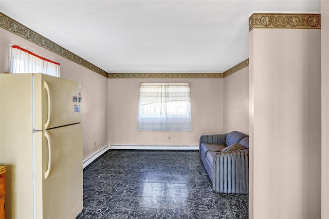 living area featuring a baseboard heating unit, plenty of natural light, and baseboard heating