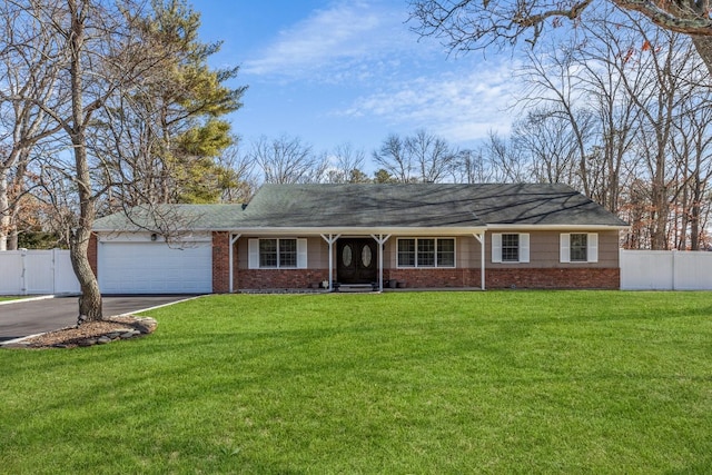 ranch-style house with driveway, an attached garage, fence, and a front yard