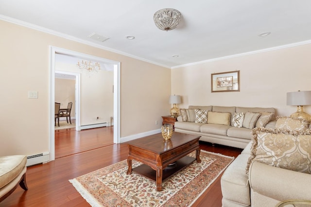 living room featuring ornamental molding, baseboard heating, and wood finished floors