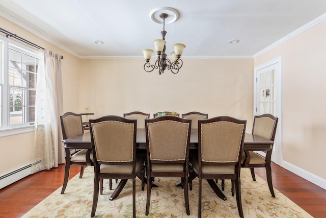 dining room featuring ornamental molding, light wood finished floors, and an inviting chandelier