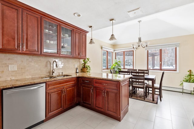 kitchen featuring a peninsula, a sink, hanging light fixtures, dishwasher, and glass insert cabinets