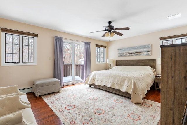 bedroom with a baseboard heating unit, access to outside, dark wood-type flooring, and ceiling fan