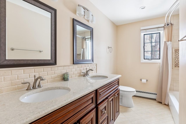 bathroom with toilet, a baseboard radiator, tasteful backsplash, and a sink