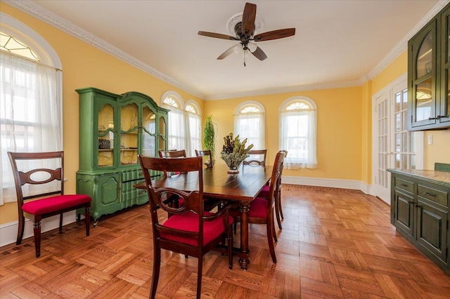 dining space featuring baseboards, ornamental molding, and ceiling fan