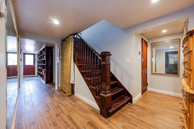 stairs featuring recessed lighting, baseboards, and wood finished floors