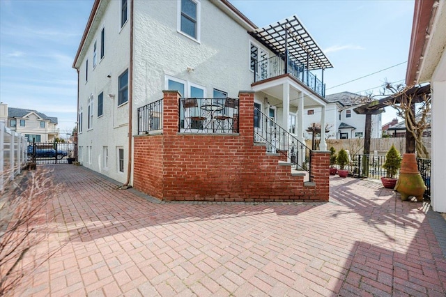 exterior space featuring fence and stucco siding