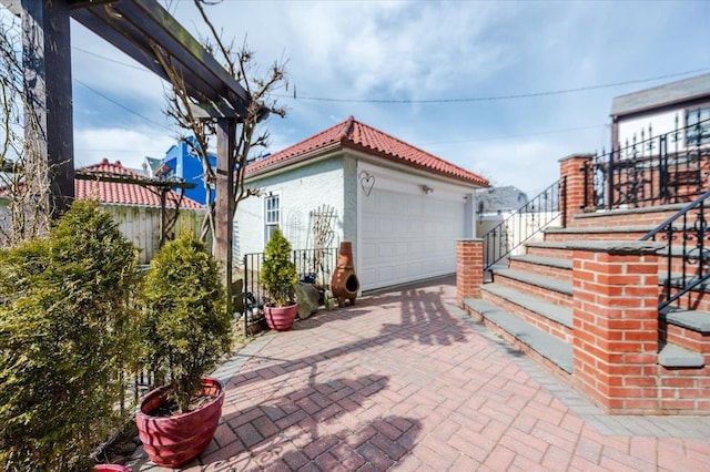 exterior space featuring fence and an outbuilding