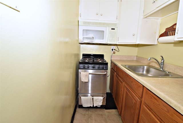 47-27 Little Neck Pkwy Unit L-2, Little Neck, NY 11362 - kitchen with white cabinets, white microwave, stainless steel gas range, light countertops, and a sink