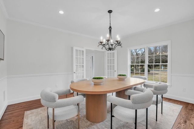 dining room featuring baseboards, ornamental molding, wood finished floors, and recessed lighting