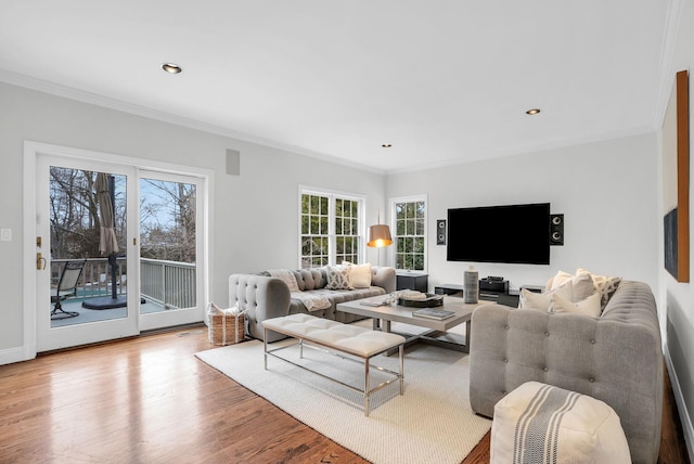 living area with recessed lighting, crown molding, and wood finished floors