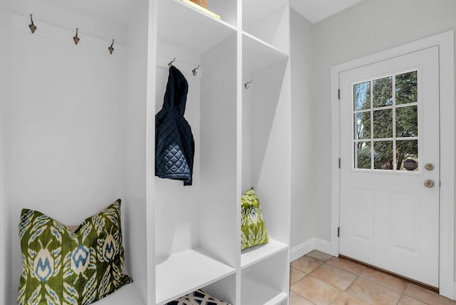 mudroom featuring baseboards and light tile patterned floors