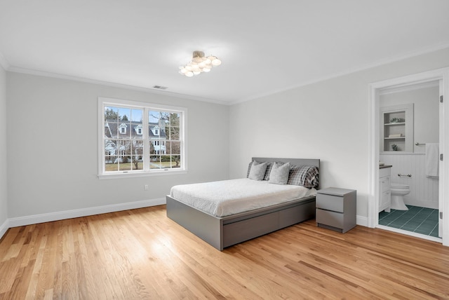 bedroom featuring ornamental molding, light wood-type flooring, and baseboards