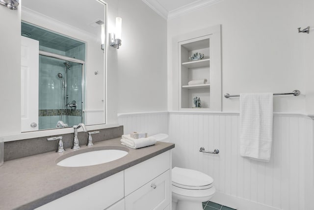 full bath with a shower stall, built in shelves, ornamental molding, and wainscoting