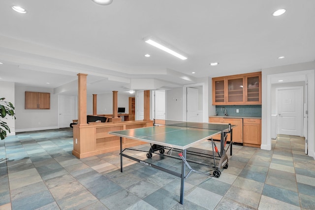 recreation room featuring recessed lighting, baseboards, and ornate columns