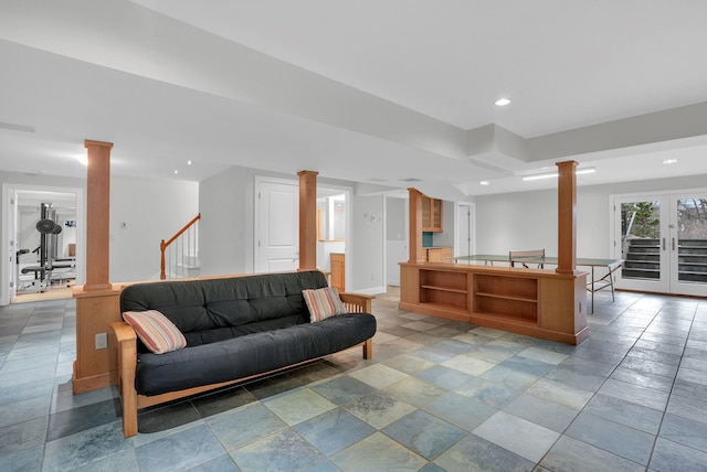 living room with decorative columns, stairway, and recessed lighting