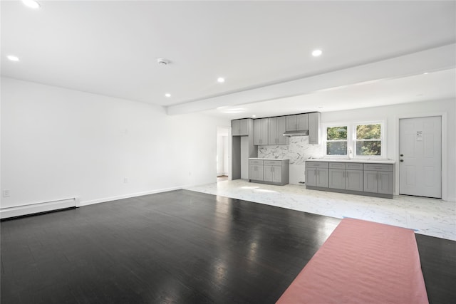 unfurnished living room featuring light wood-style floors, a baseboard radiator, baseboards, and recessed lighting